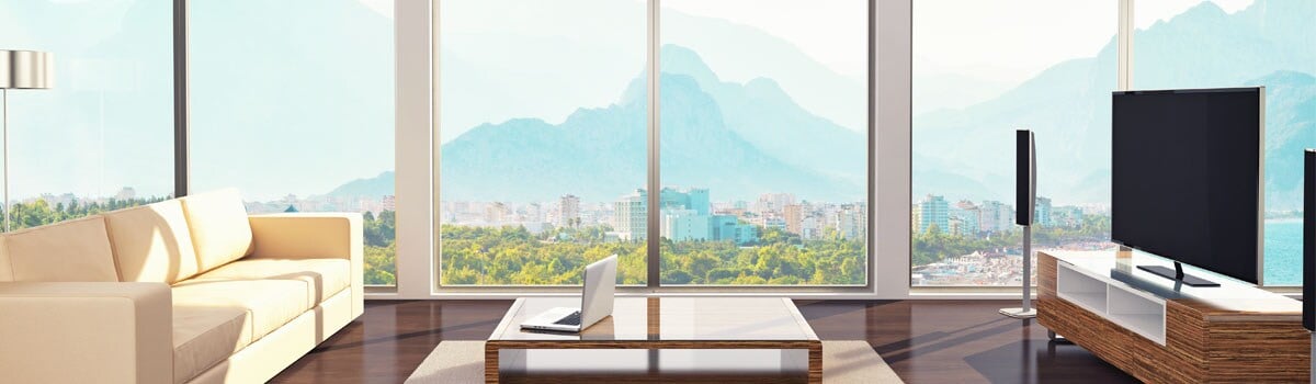 Family room with a TV and sunny windows